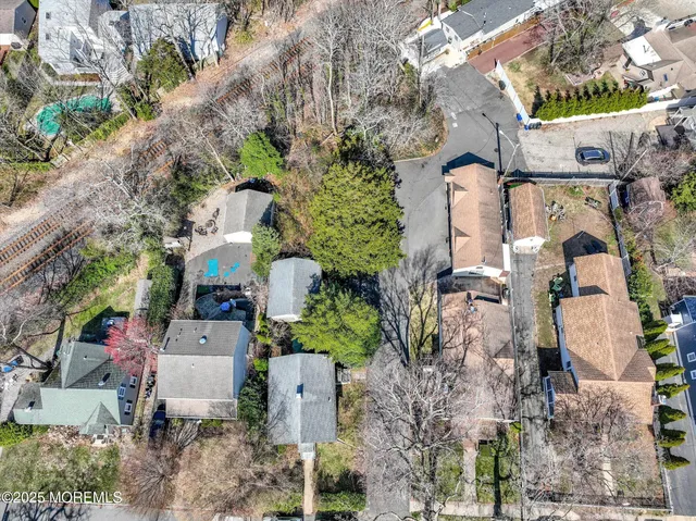 an aerial view of a house with a yard and fountain