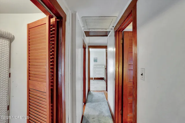 an empty room with windows and cabinet