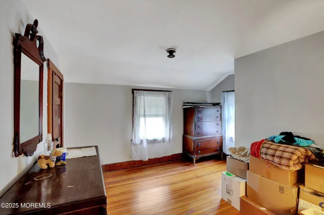 a bedroom with bed and a window