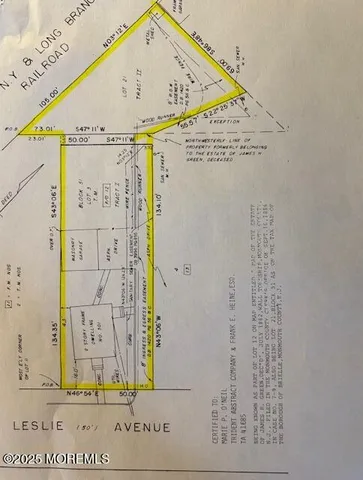 a white house that has a tree in front of it