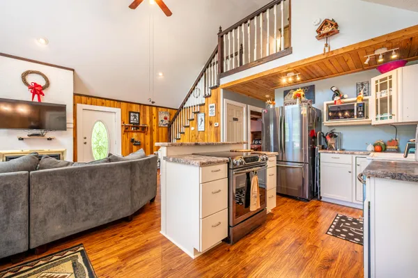 a kitchen with stainless steel appliances granite countertop a stove a sink and a refrigerator