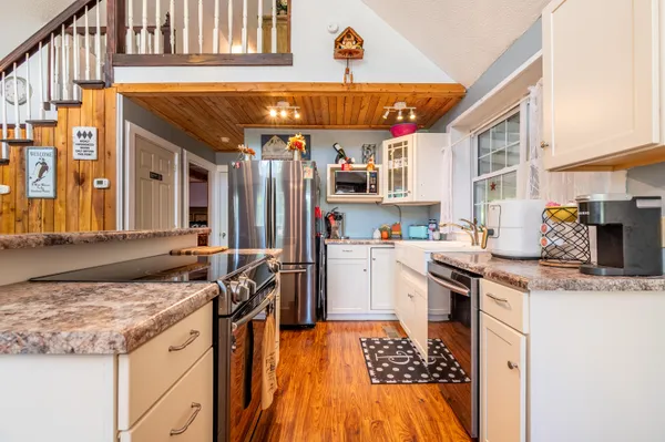 a kitchen with a sink stove and refrigerator