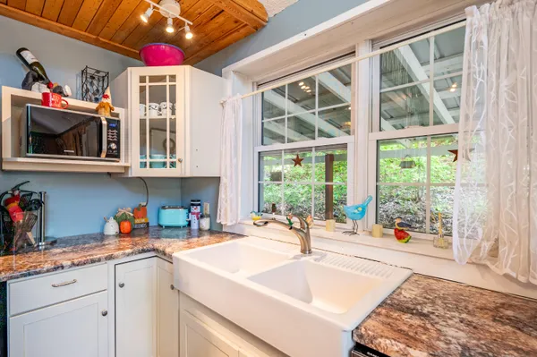 a kitchen with a stove a sink and a microwave