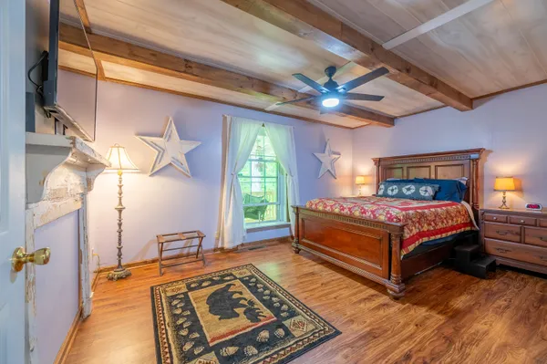 a bedroom with a bed and a flat screen tv