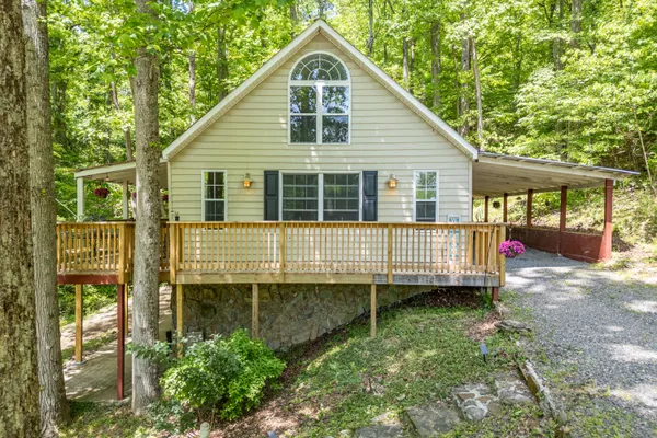 a view of a house with a backyard and balcony