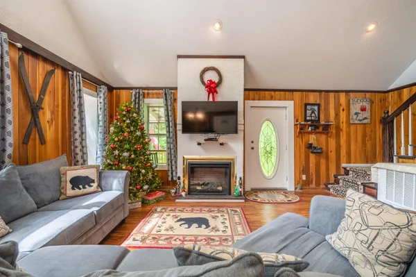 a living room with furniture fireplace and flat screen tv