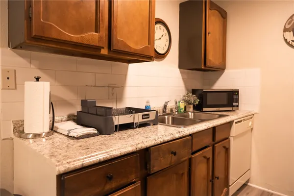 a kitchen with appliances cabinets and a sink