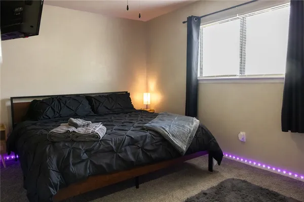 a bedroom with a bed and window