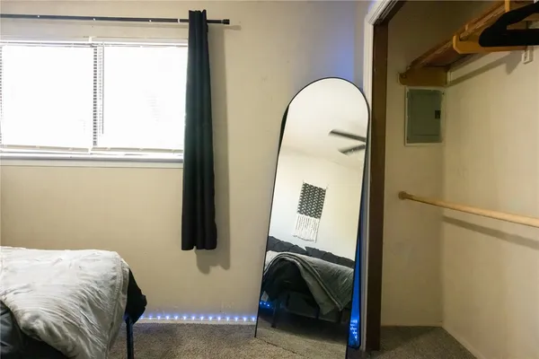 a bedroom with a bed and a mirror