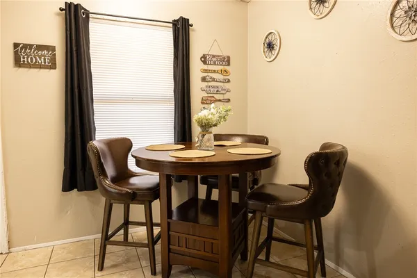 a view of a dining room with furniture and window
