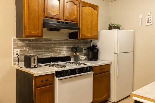 a kitchen with a stove and a refrigerator