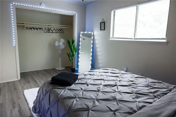 a bedroom with a bed and a window