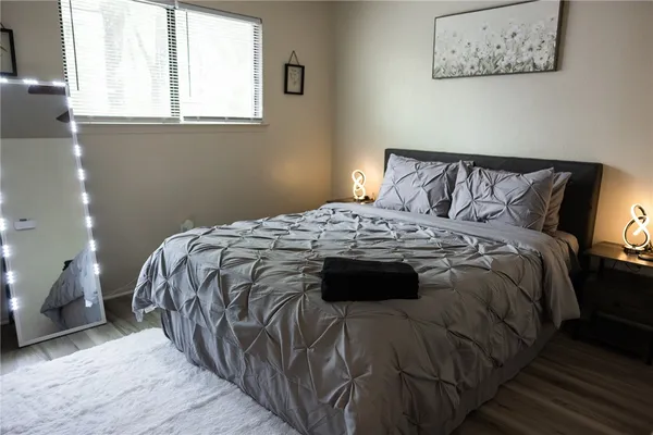 a bed sitting in a bedroom next to a window