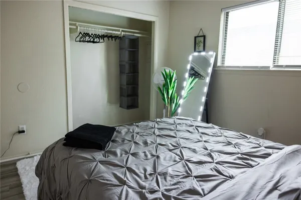 a bedroom with a bed and a window