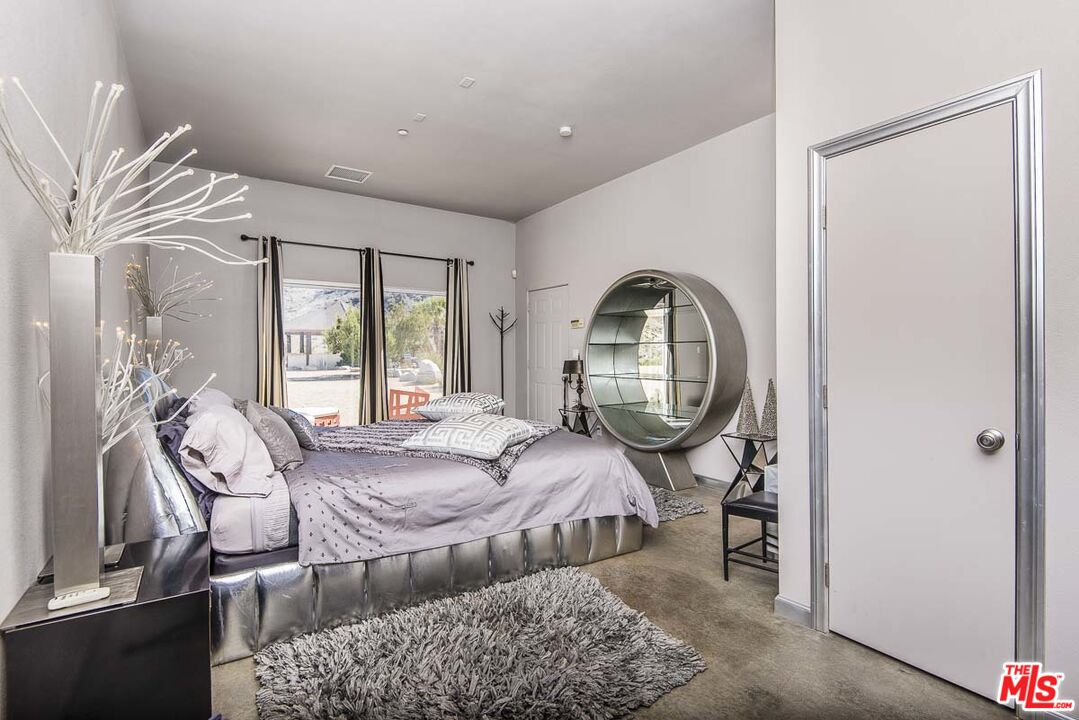 3569 Calmada Road Pioneertown, CA 92268 - Photo 13 of 18 a bed room with a bed and a window