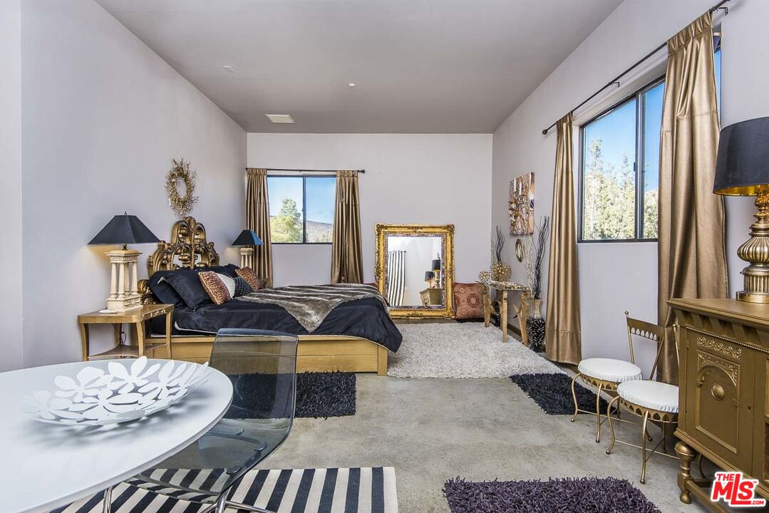 3569 Calmada Road Pioneertown, CA 92268 - Photo 14 of 18 a living room with furniture and a table