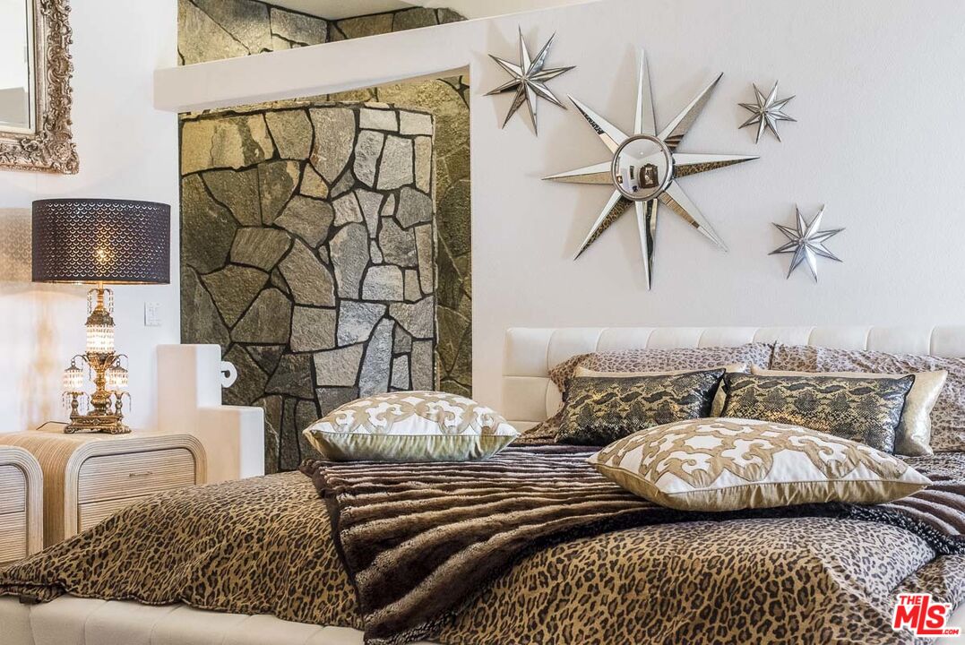 3569 Calmada Road Pioneertown, CA 92268 - Photo 15 of 18 a bedroom with a bed and a couch