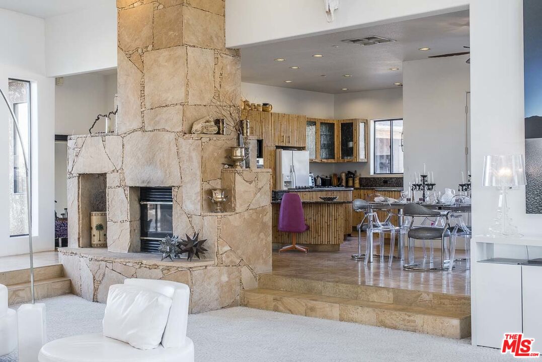 3569 Calmada Road Pioneertown, CA 92268 - Photo 16 of 18 a living room with stainless steel appliances kitchen island granite countertop a table and chairs