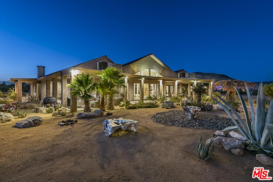 3569 Calmada Road Pioneertown, CA 92268 - Photo 4 of 18 a view of a house with swimming pool and sitting area