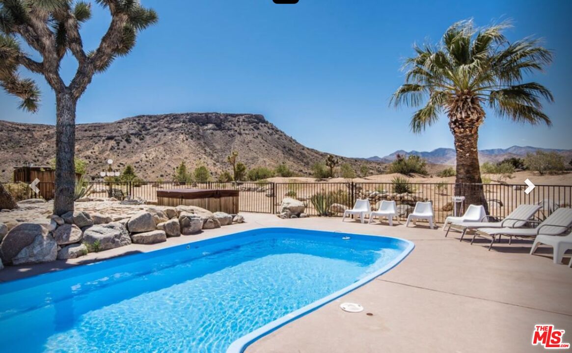 3569 Calmada Road Pioneertown, CA 92268 - Photo 5 of 18 a view of a swimming pool and lounge chair