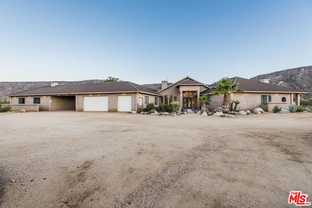 3569 Calmada Road Pioneertown, CA 92268 - Photo 6 of 18 a front view of a house with a yard