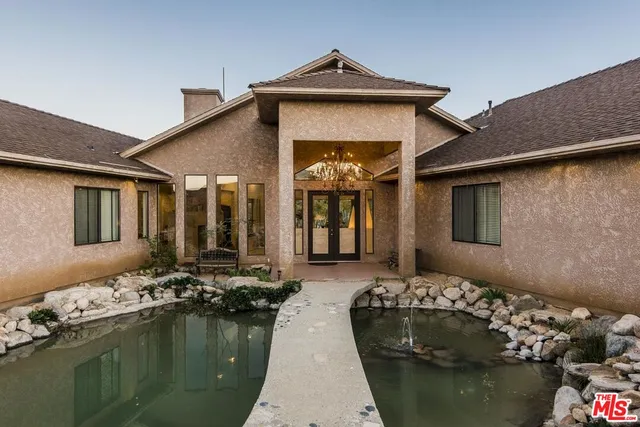 a large white kitchen with a large window and table