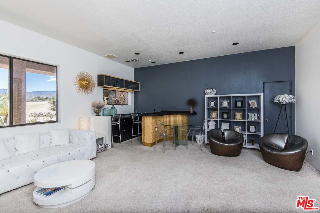 3569 Calmada Road Pioneertown, CA 92268 - Photo 9 of 18 a living room with furniture and a large window
