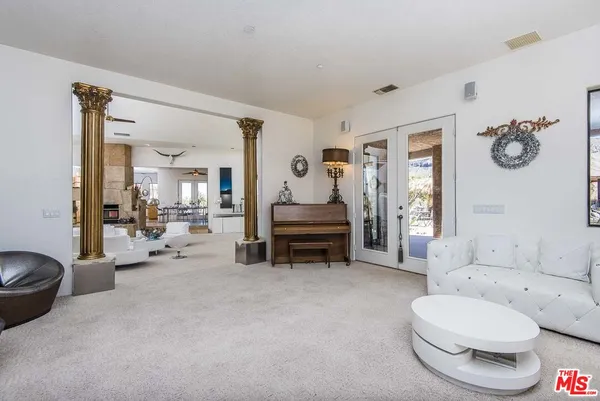 a living room with stainless steel appliances kitchen island granite countertop furniture and a kitchen view
