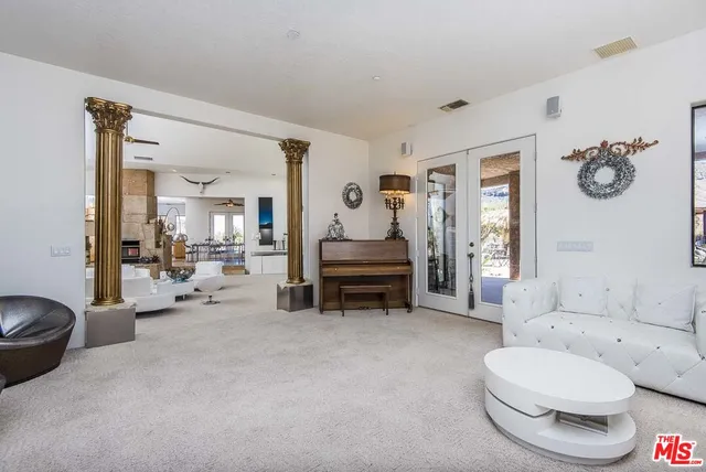 a living room with stainless steel appliances kitchen island granite countertop furniture and a kitchen view