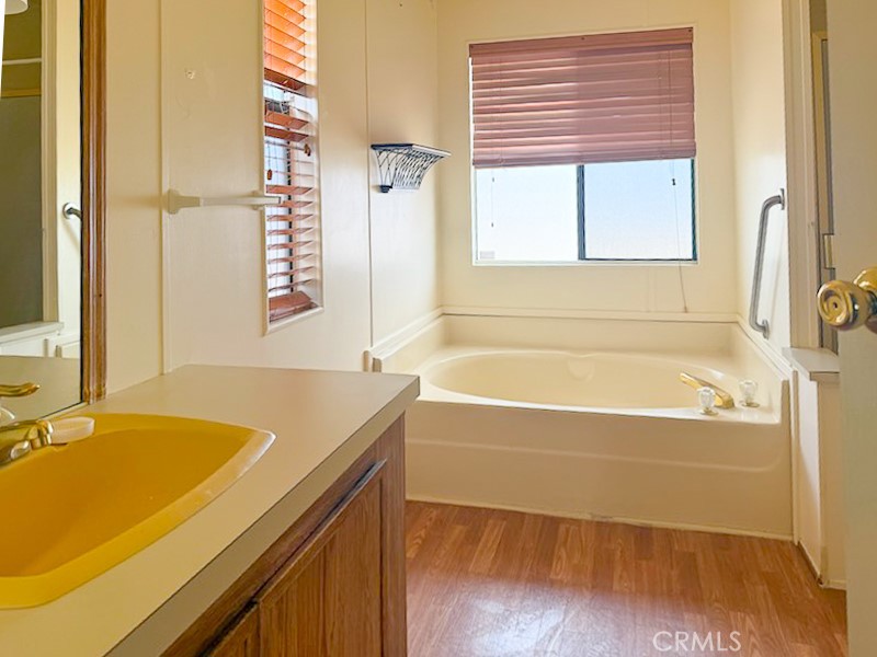 6450 Maricopa Road Phelan, CA 92371 - Photo 13 of 16 a bathroom with a tub a sink and a window
