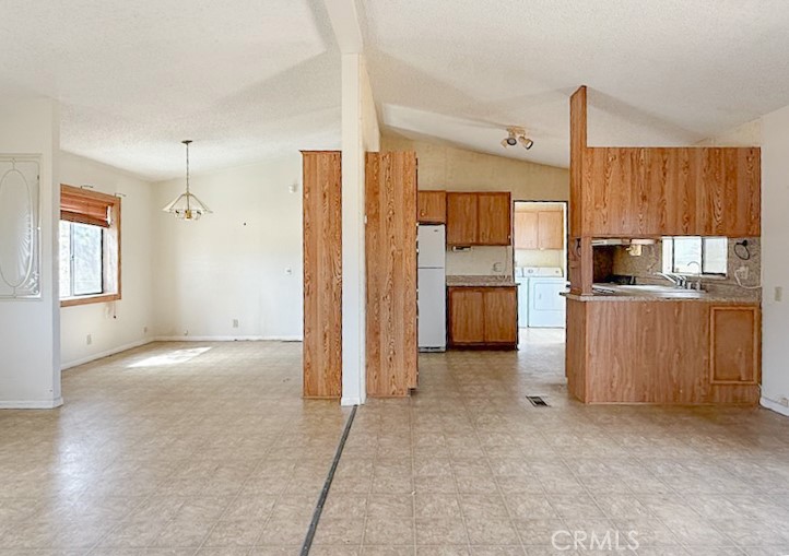 6450 Maricopa Road Phelan, CA 92371 - Photo 3 of 16 a view of a kitchen with refrigerator and cabinets