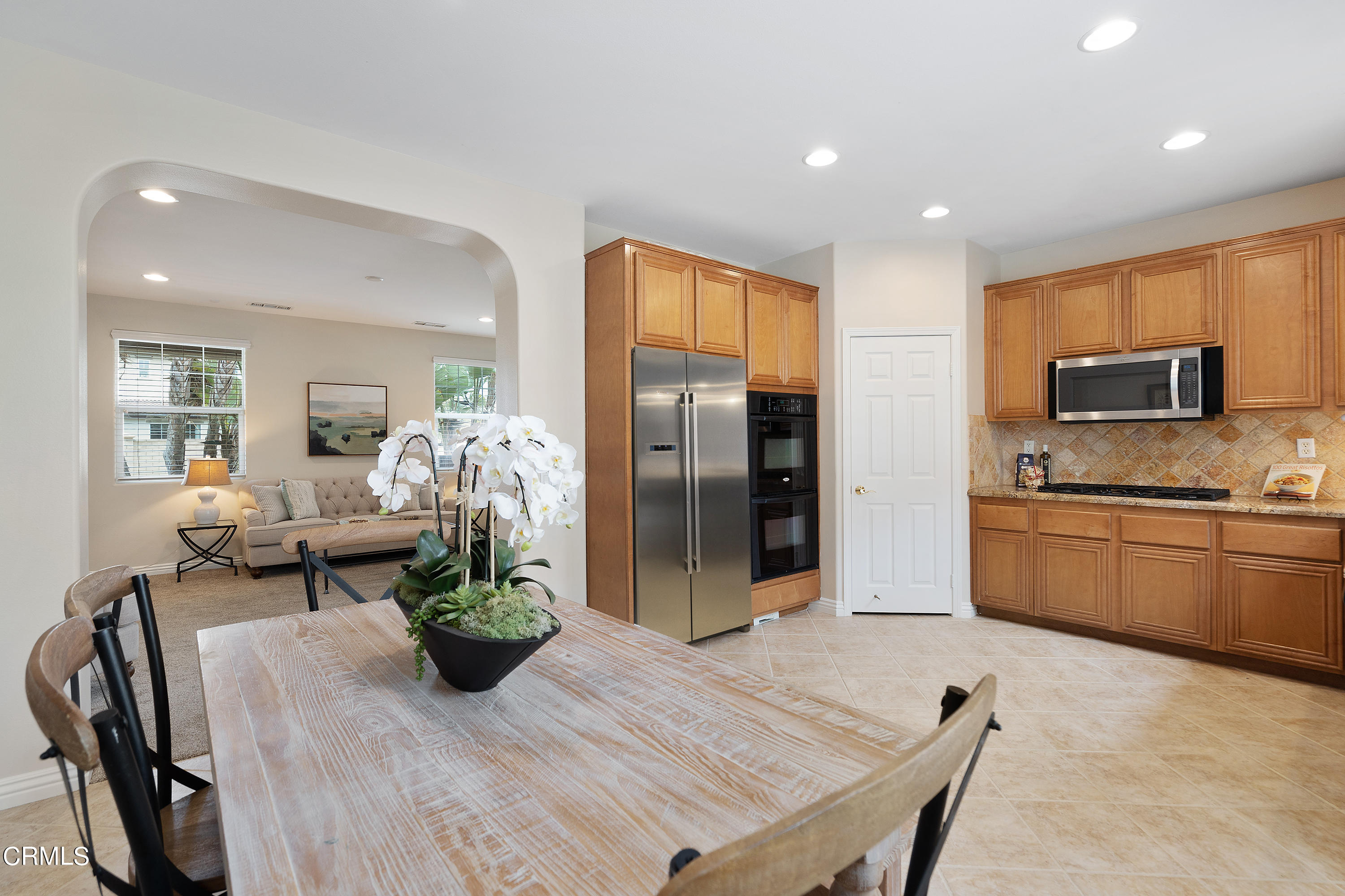 551 Spring Park Road Camarillo, CA 93012 - Photo 9 of 36 a kitchen with a table chairs refrigerator and microwave