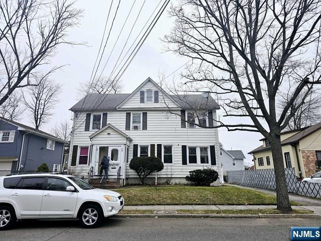 59 Robinson Street, Unit 1R Teaneck, NJ 07666 - Photo 2 of 6 a white house covered with tall trees