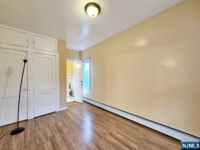 59 Robinson Street, Unit 1R Teaneck, NJ 07666 - Photo 4 of 6 a view of an empty room with wooden floor and a window
