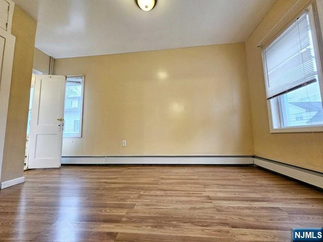 59 Robinson Street, Unit 1R Teaneck, NJ 07666 - Photo 5 of 6 a view of an empty room with wooden floor and a window