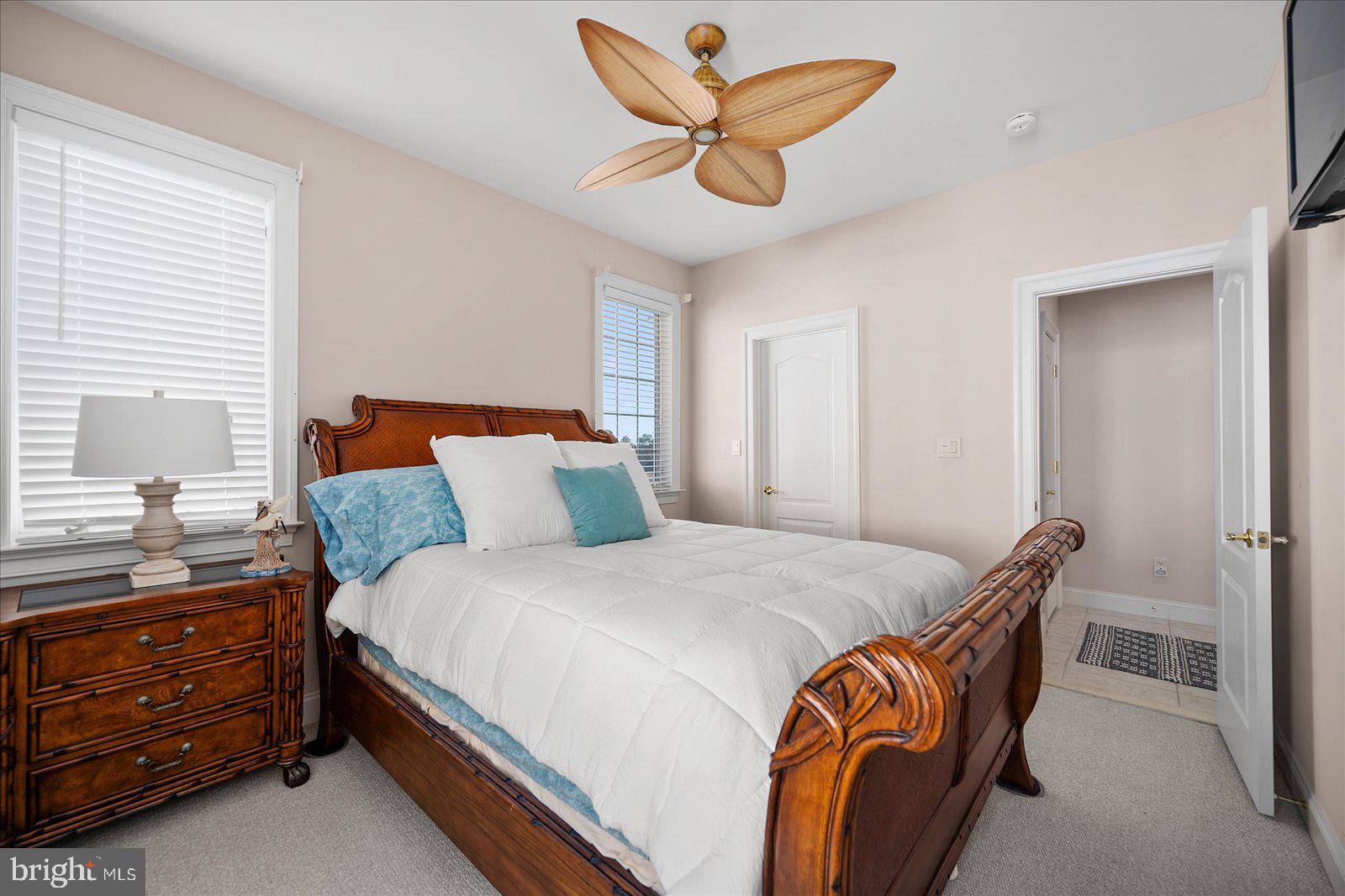 12901 Old Bridge Road, Unit PH8 2 Ocean City, MD 21842 - Photo 40 of 79 a bedroom with a bed and a chandelier