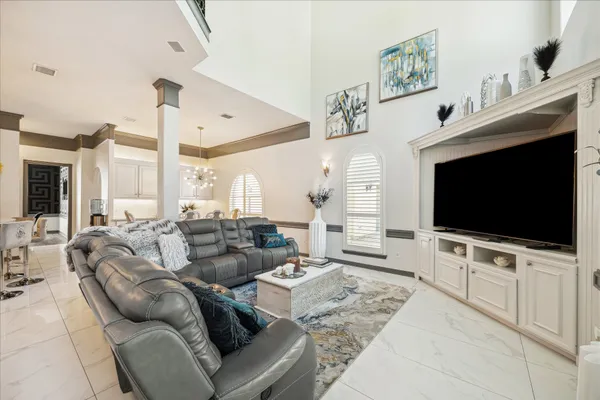a bedroom with a large bed and a chandelier