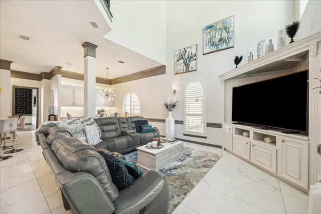 a bedroom with a large bed and a chandelier