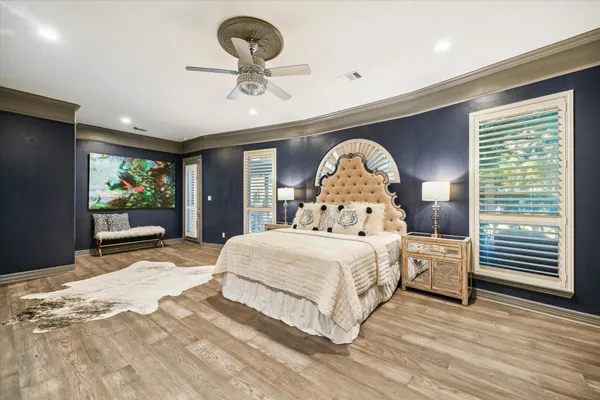 a bedroom with a large bed and a large window