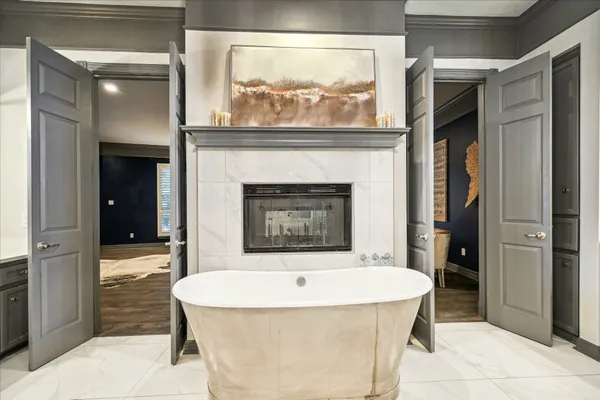 a bathroom with a tub shower and sink