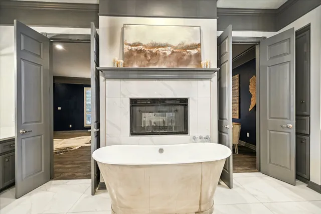a bathroom with a tub shower and sink