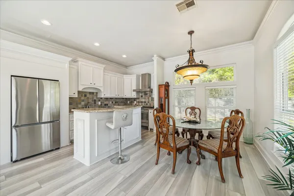 a kitchen with stainless steel appliances granite countertop a refrigerator sink and cabinets