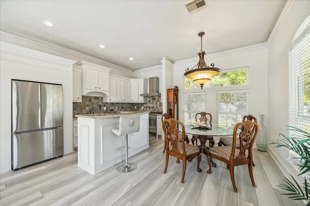 a kitchen with stainless steel appliances granite countertop a refrigerator sink and cabinets