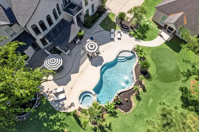 a front view of a house with swimming pool having outdoor seating