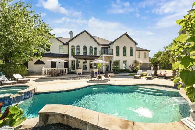 a kitchen with stainless steel appliances granite countertop a sink a stove and a wooden floors
