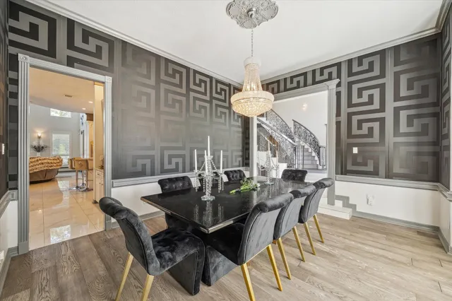 a view of a dining room with furniture and a chandelier