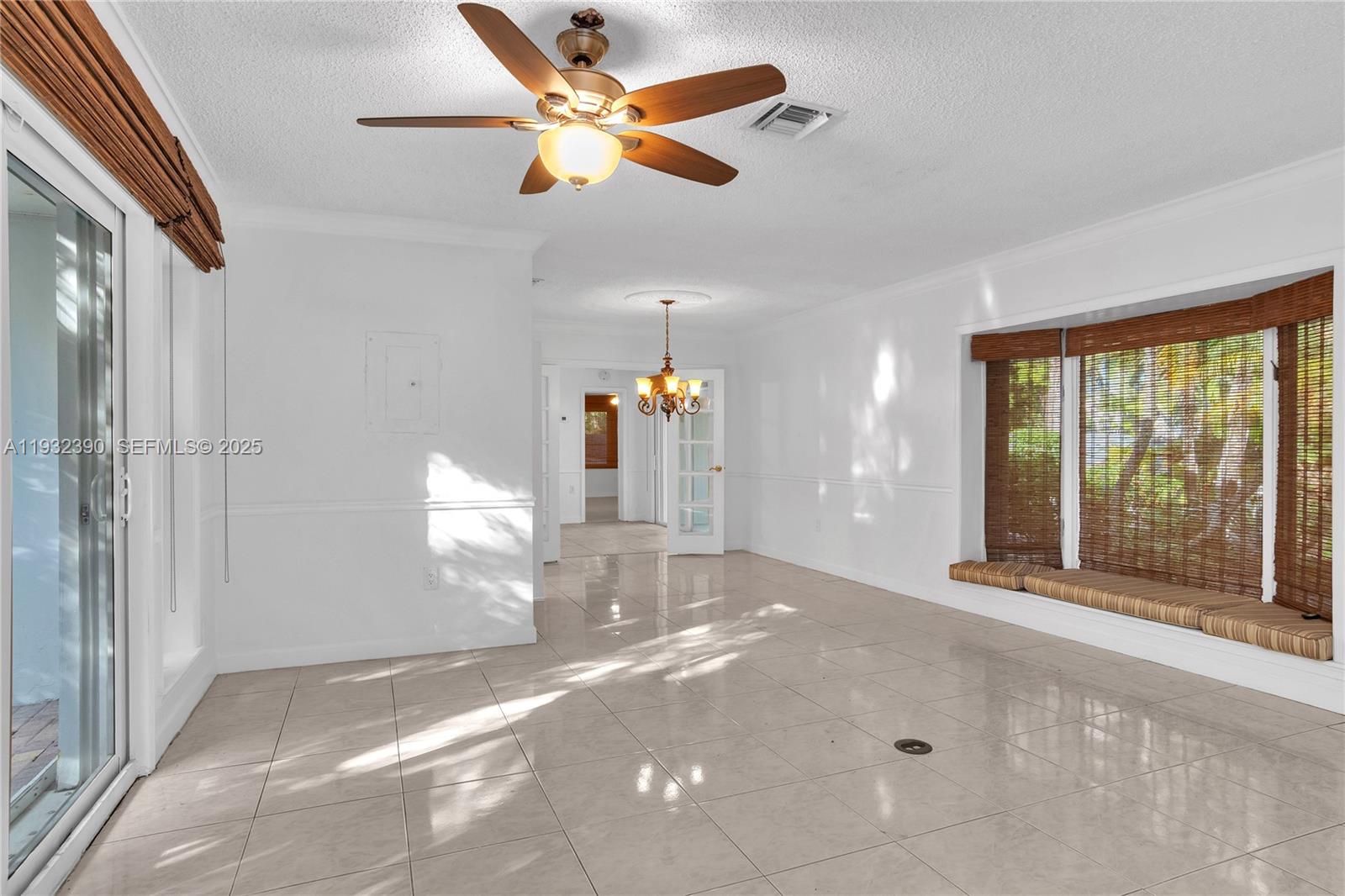 205 Northeast 16th Terrace Fort Lauderdale, FL 33301 - Photo 11 of 21 a view of a livingroom with a ceiling fan and window