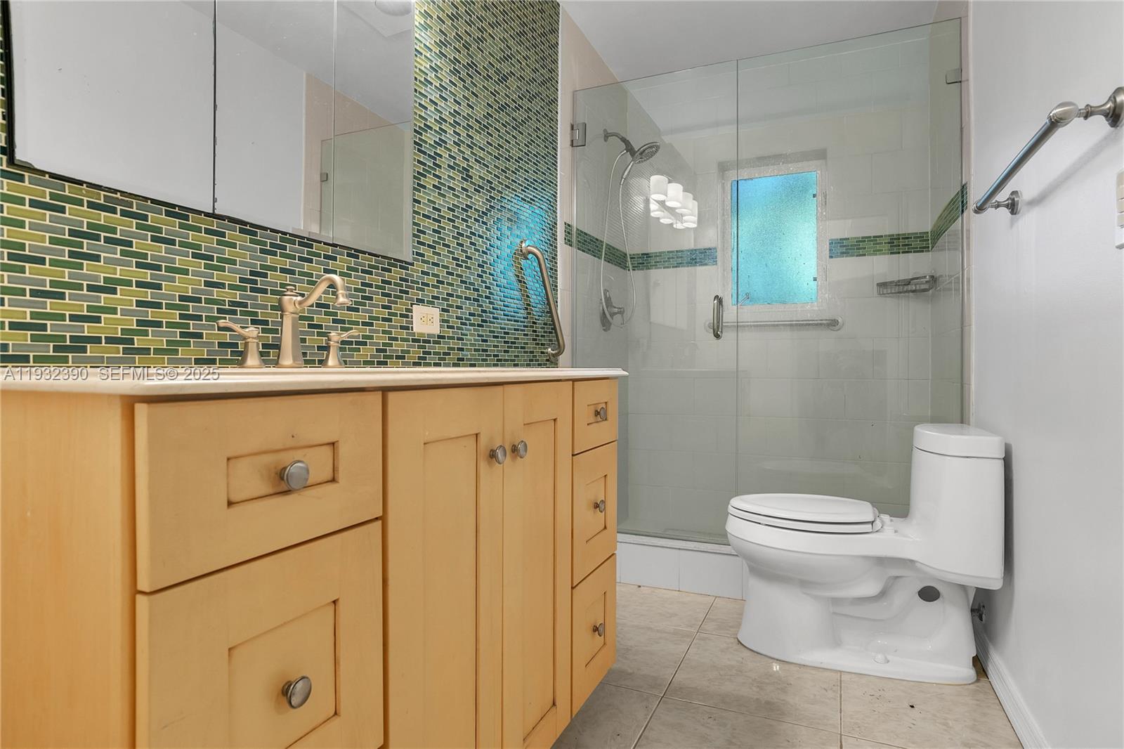 205 Northeast 16th Terrace Fort Lauderdale, FL 33301 - Photo 16 of 21 a bathroom with a sink a toilet and a mirror