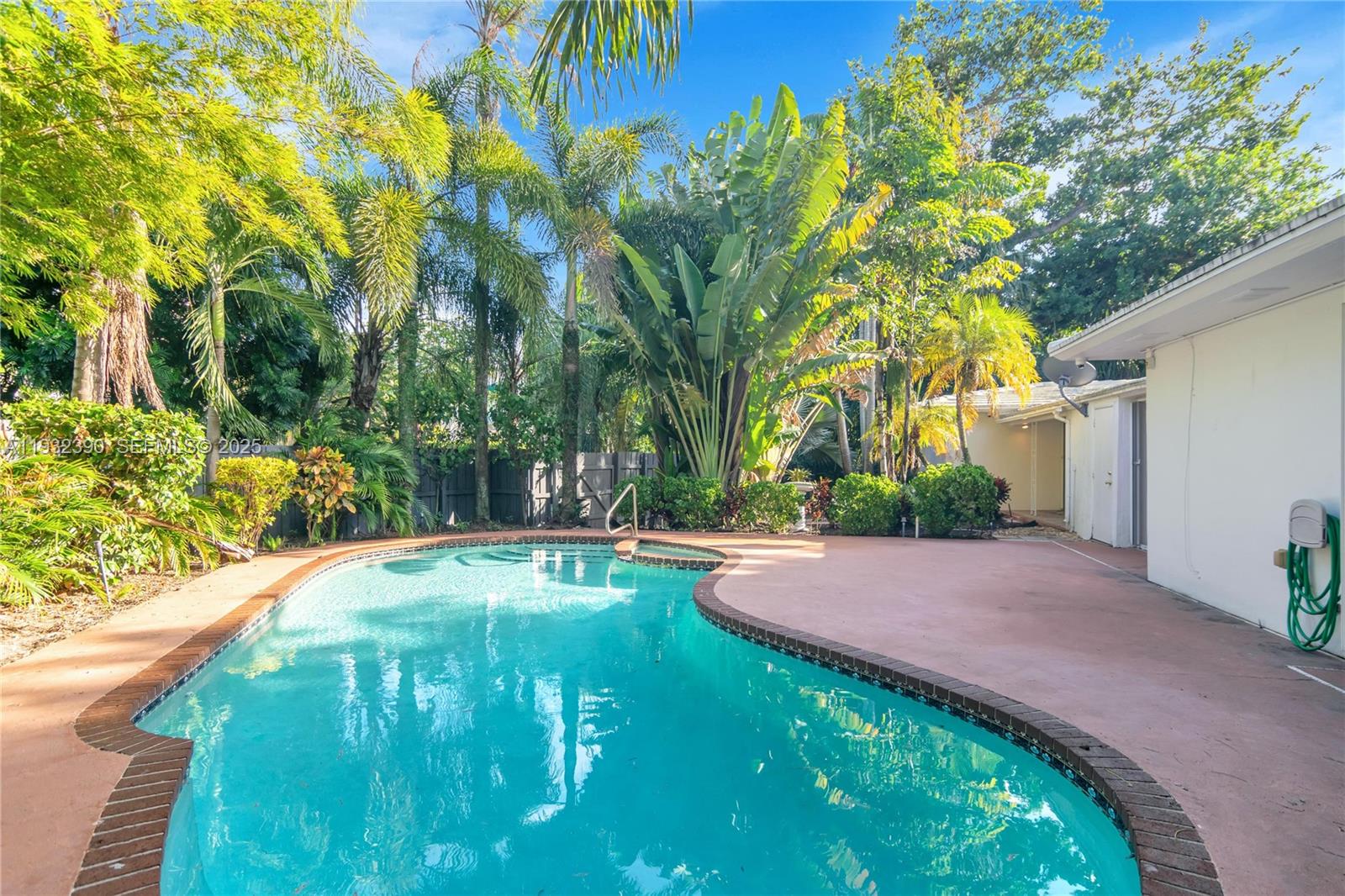 205 Northeast 16th Terrace Fort Lauderdale, FL 33301 - Photo 4 of 21 a backyard of a house with table and chairs