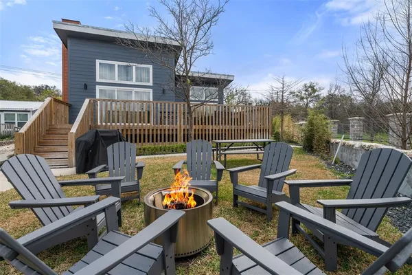 a view of deck with furniture and wooden fence